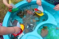 Children Playing with Boats and Sea Creature/Ocean Life Toys in a Water Table Royalty Free Stock Photo