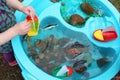 Children Playing with Boats and Sea Creature/Ocean Life Toys in a Water Table Royalty Free Stock Photo