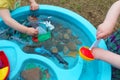 Children Playing with Boats and Sea Creature/Ocean Life Toys in a Water Table Royalty Free Stock Photo