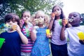 Children playing with bubble wand in the park Royalty Free Stock Photo