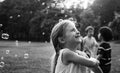 Children is playing bubbles in a park Royalty Free Stock Photo