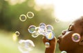 Children is playing bubbles in a park