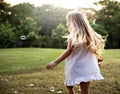 Children is playing bubbles in a park