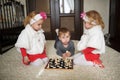 Children playing chess lying on floor Royalty Free Stock Photo
