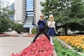 Children playing in the city park looking at flowers with a magnifying glass Royalty Free Stock Photo