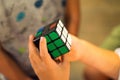 Children playing colorful rubik`s cube