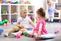 Children playing with colorful toys. Little kid girl and toddler boy with educational toy blocks. Children play at day Royalty Free Stock Photo