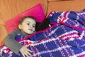 Children playing with cuddly toys covered in a sofa