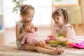 Children playing doctor with doll indoor