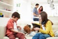 Children Playing With Dog On Sofa Royalty Free Stock Photo