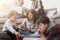 Children playing on the floor while parents on sofa Royalty Free Stock Photo