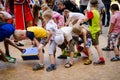 Children playing fun game pass each other box between their legs at pirate party