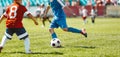 Children playing the game on football soccer stadium field. Boys compete during a soccer tournament match