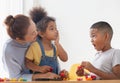 Children playing game with grandparents in living room, Grandchildren mould from plasticine with grandmother Royalty Free Stock Photo