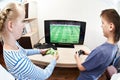 Children playing on games console to play football Royalty Free Stock Photo