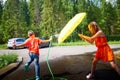 Children playing with garden sprinkler. Brother and sister running and jumping. Summer outdoor water fun in backyard