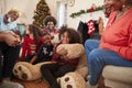 Children Playing With Giant Teddy Bear As Multi-Generation Family Open Gifts On Christmas Day Royalty Free Stock Photo