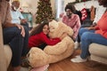 Children Playing With Giant Teddy Bear As Multi-Generation Family Open Gifts On Christmas Day Royalty Free Stock Photo