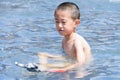 A child is playing happily in the water