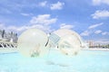 Children playing inside a transparent ball on water Royalty Free Stock Photo