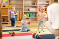 Children playing in kindergarten with a teacher Royalty Free Stock Photo