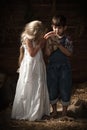 Children playing with a kitten in the barn Royalty Free Stock Photo