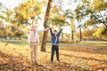 Children playing with leaves in autumn park Royalty Free Stock Photo