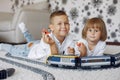 Children playing with lego and toy train in a playing room