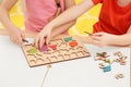 Children playing with math game kit at desk indoors, closeup. Learning mathematics with fun Royalty Free Stock Photo
