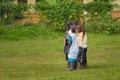 Children playing on a meadow on a cloudy day in May