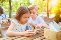 Children playing with mobile phone at terrace - Portrait of positive kids having fun together with smart phone