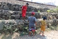 children playing near the river stone gabion during the day