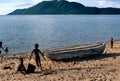 Children playing next to a pirogue, Lake Malawi.