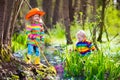 Children playing outdoors catching frog