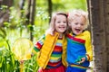 Children playing outdoors catching frog