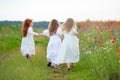 Children playing outdoors. Three girls run moving away Royalty Free Stock Photo