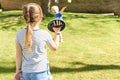 Children playing outside a brother and sister play a ball game in a garden Royalty Free Stock Photo