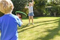 Children playing outside a brother and sister play a ball game in a garden Royalty Free Stock Photo