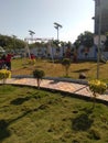 Children playing in the park have greenery all around it