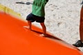 Children playing on a plastic inflatable tarpaulin. it`s a bubble that jumps on. the compressor inflates it and there is silica sa