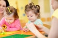 Children playing with plasticine at kindergarten or playschool