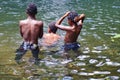 Children playing in a pool at the base of a waterfall in Ecuador Royalty Free Stock Photo