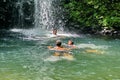 Children playing in a pool at the base of a waterfall in Ecuador Royalty Free Stock Photo