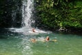 Children playing in a pool at the base of a waterfall in Ecuador Royalty Free Stock Photo