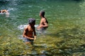 Children playing in a pool at the base of a waterfall in Ecuador Royalty Free Stock Photo