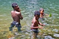 Children playing in a pool at the base of a waterfall in Ecuador Royalty Free Stock Photo