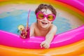 Children playing in pool. Child water toys. Stylish sunglasses. Beach Clubs in Ibiza. Beach party. Child swimming pool
