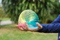 Children playing with rainbow colored wire spiral