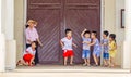 Children playing and romping around at the entrance of a cathedral in Cai Be, Vietnam