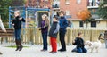 Children playing rubber band jumping game and laughing